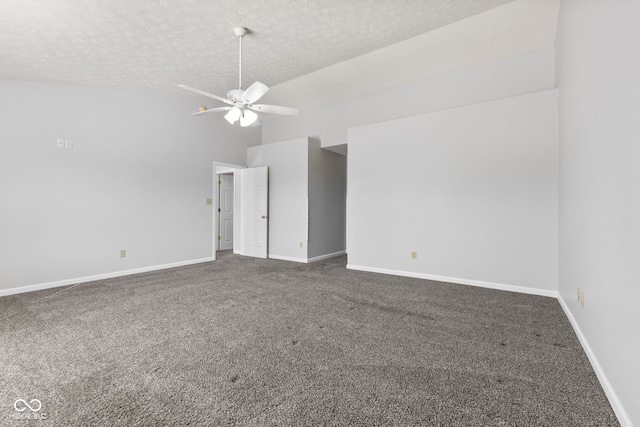 carpeted spare room with baseboards, a textured ceiling, a ceiling fan, and vaulted ceiling