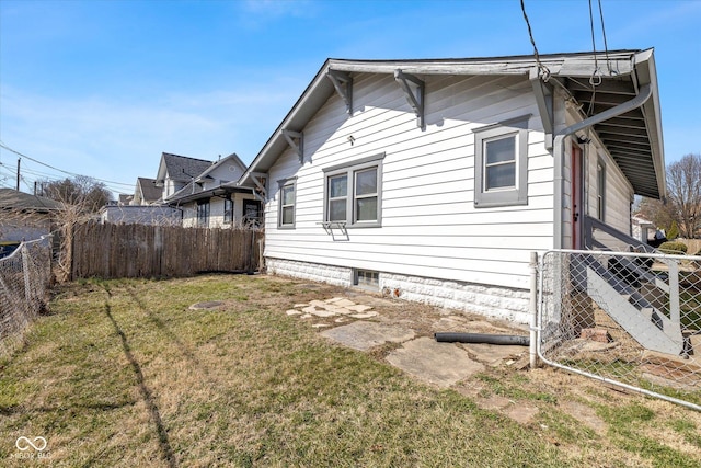 view of home's exterior with a yard and fence private yard