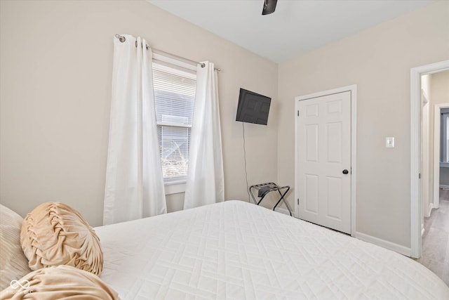 bedroom with baseboards and ceiling fan