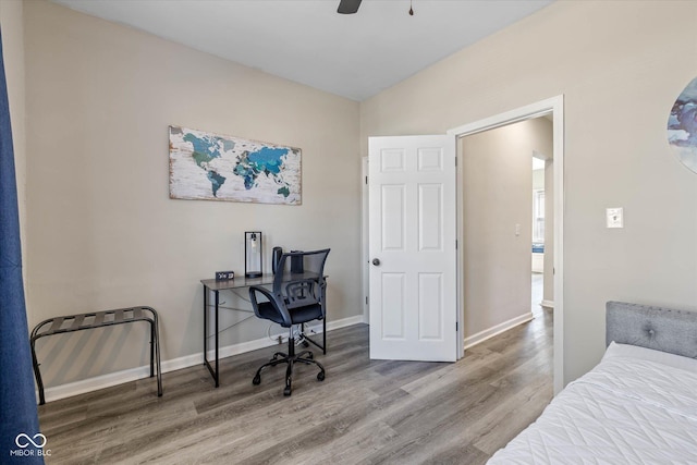 bedroom featuring baseboards and wood finished floors