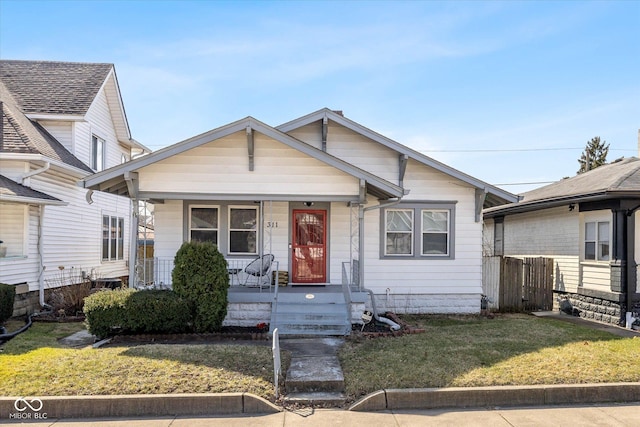 view of front of house with covered porch and a front yard