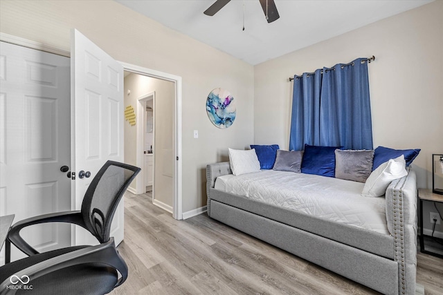 interior space with baseboards, light wood-type flooring, and a ceiling fan