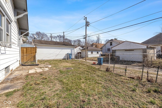 view of yard featuring an outdoor structure and fence