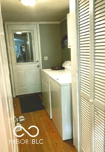 laundry area with washer and dryer and dark wood-style floors