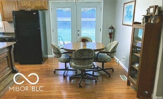 dining room with visible vents, french doors, light wood-type flooring, and baseboards