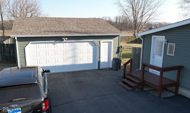 detached garage featuring fence