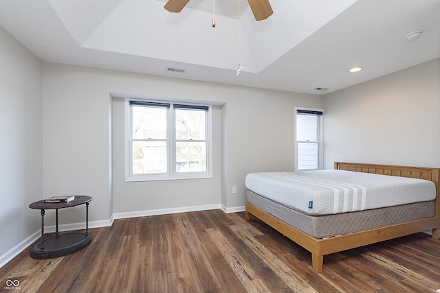 bedroom with visible vents, baseboards, recessed lighting, wood finished floors, and a textured ceiling