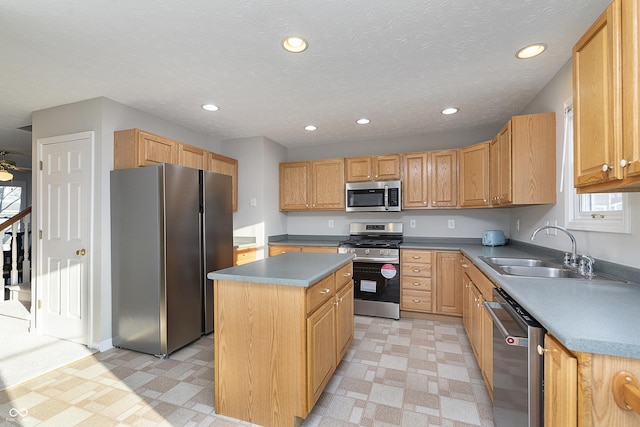 kitchen featuring a kitchen island, light floors, recessed lighting, appliances with stainless steel finishes, and a sink