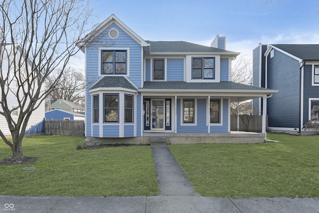 view of front of home featuring a shingled roof, fence, a porch, a front yard, and a chimney