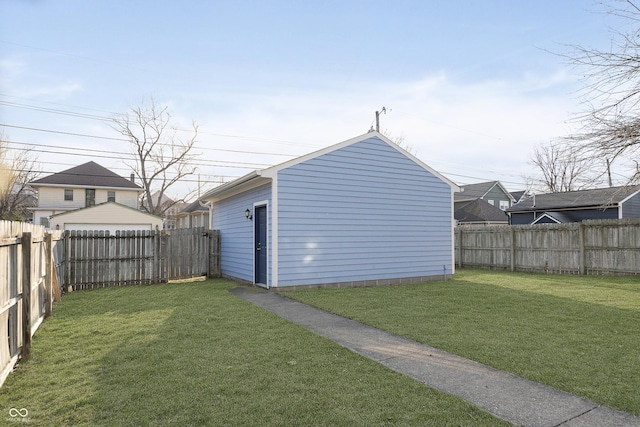 view of yard with an outdoor structure and a fenced backyard