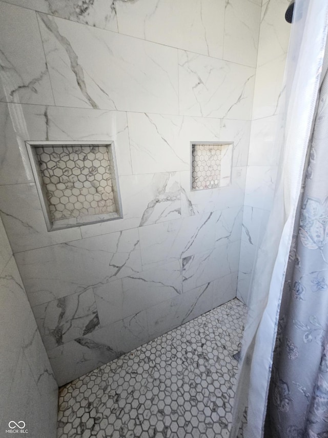 full bathroom with tiled shower