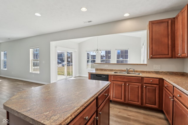 kitchen featuring visible vents, light wood finished floors, an inviting chandelier, recessed lighting, and a sink