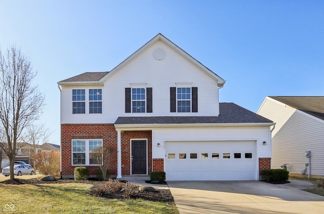 traditional-style home with a garage, brick siding, and driveway