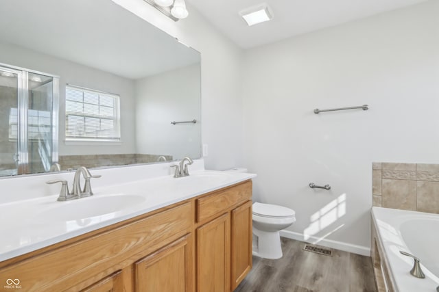 full bath featuring a sink, visible vents, toilet, and a bath