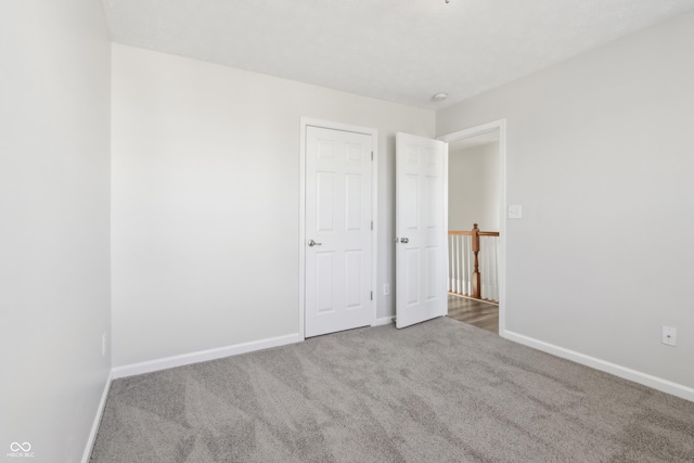 empty room featuring baseboards and carpet floors