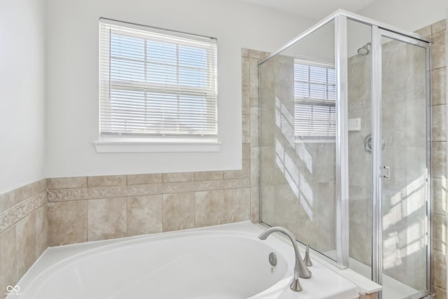 bathroom with a garden tub and a stall shower