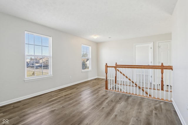 spare room with wood finished floors and baseboards