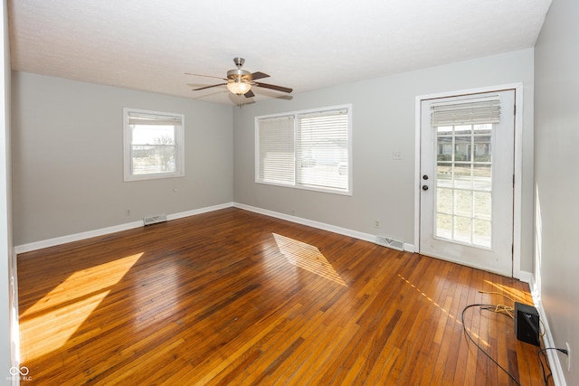 empty room featuring visible vents, baseboards, and a ceiling fan