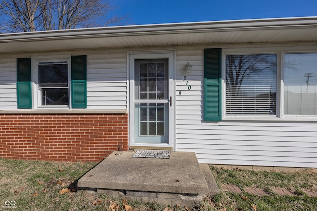 property entrance with brick siding