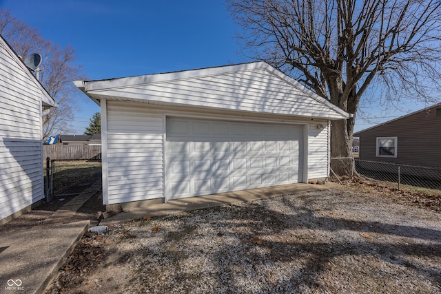 detached garage featuring fence