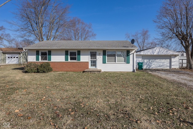 single story home featuring a garage, a front yard, an outdoor structure, and a shingled roof