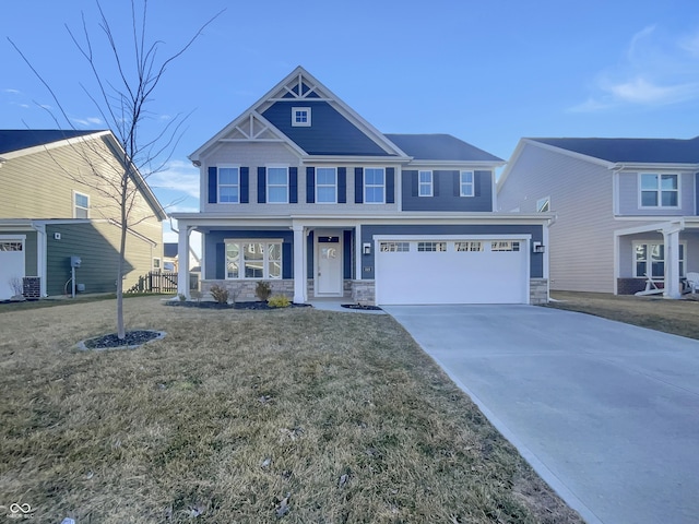 craftsman-style home with a front yard, a garage, stone siding, and driveway