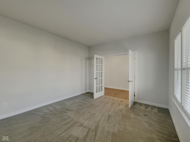 interior space with french doors, baseboards, and carpet floors