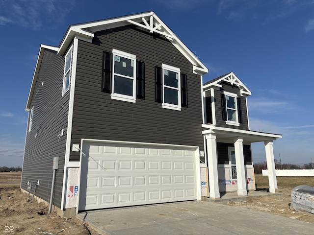 traditional home with an attached garage and driveway