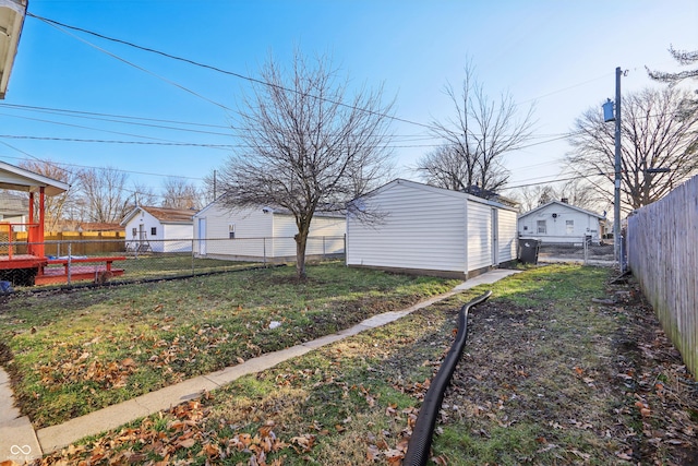 view of yard featuring an outdoor structure and a fenced backyard