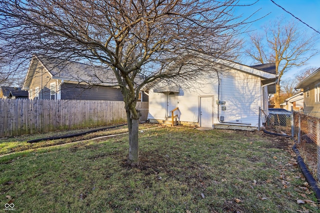 view of yard featuring entry steps and fence