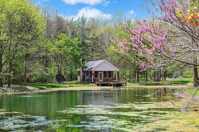 property view of water featuring a wooded view