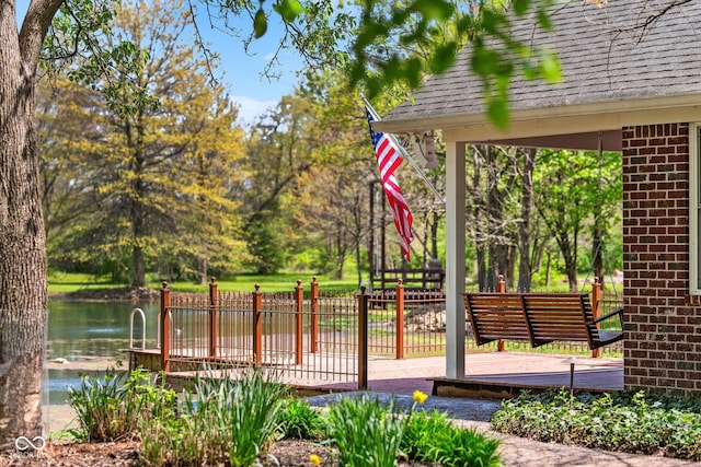 deck with fence and a water view