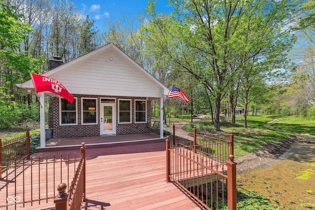 wooden terrace with fence and a porch