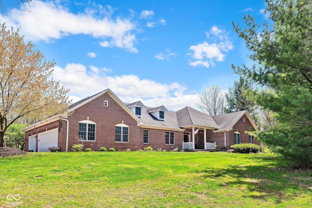 view of front of house with brick siding, a front lawn, and an attached garage