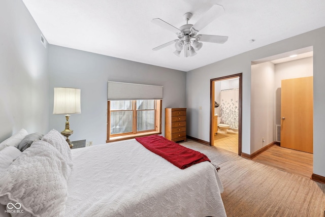 bedroom with baseboards, ceiling fan, and ensuite bathroom