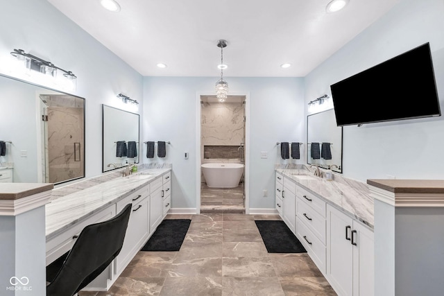 full bathroom with recessed lighting, a sink, a freestanding tub, and two vanities