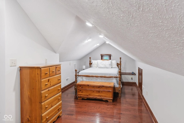 bedroom featuring baseboards, a textured ceiling, dark wood-style flooring, and vaulted ceiling