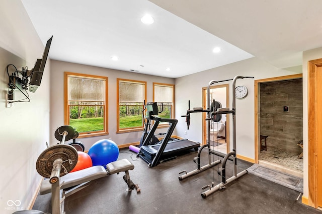workout area featuring recessed lighting and baseboards