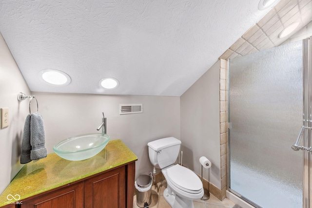 bathroom featuring vanity, toilet, a textured ceiling, a shower stall, and visible vents