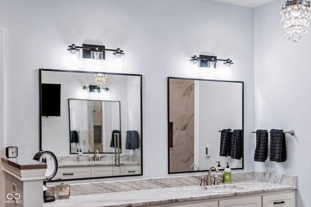 full bath with vanity and a chandelier