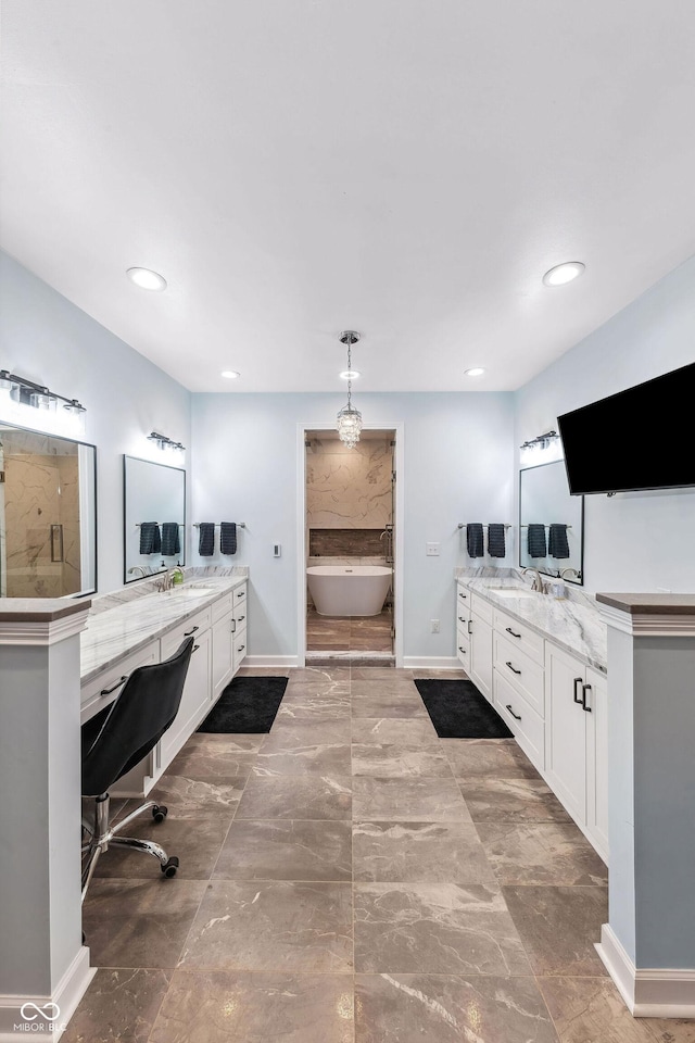 full bath with a sink, two vanities, and marble finish floor