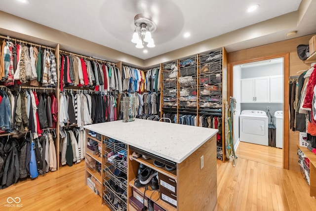 spacious closet with light wood finished floors and washer and clothes dryer