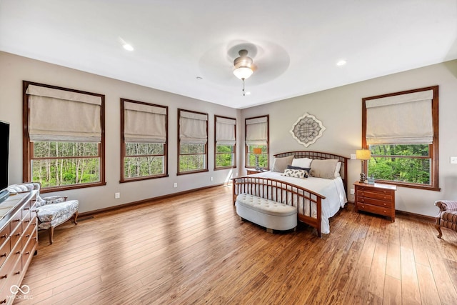 bedroom with baseboards, ceiling fan, wood-type flooring, and recessed lighting