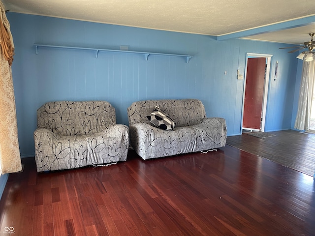 living area featuring ceiling fan and wood finished floors