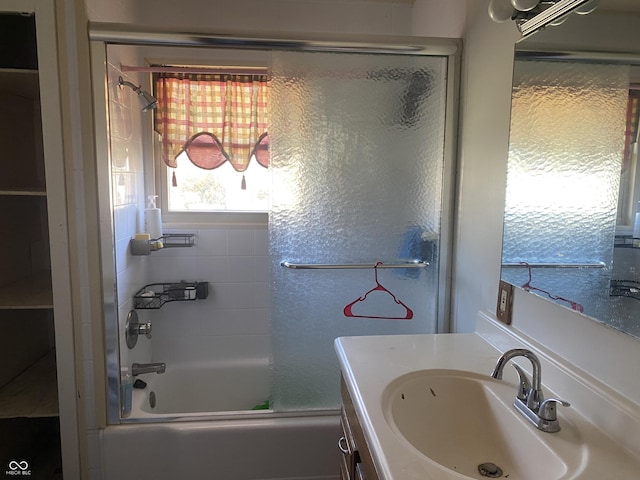 full bath featuring vanity and bath / shower combo with glass door