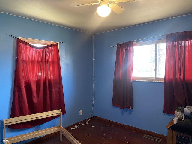 unfurnished bedroom with a ceiling fan and visible vents