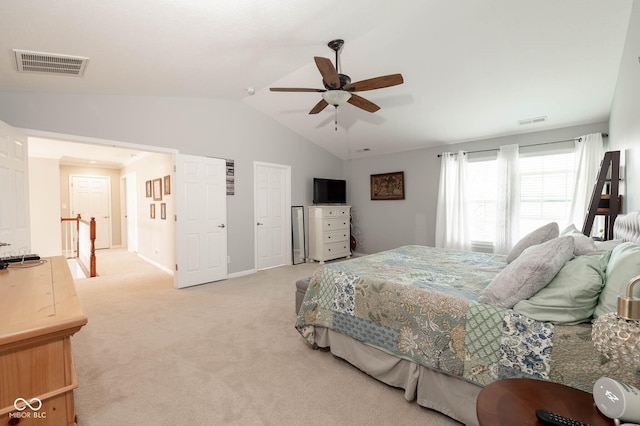 bedroom with lofted ceiling, a ceiling fan, visible vents, and light carpet