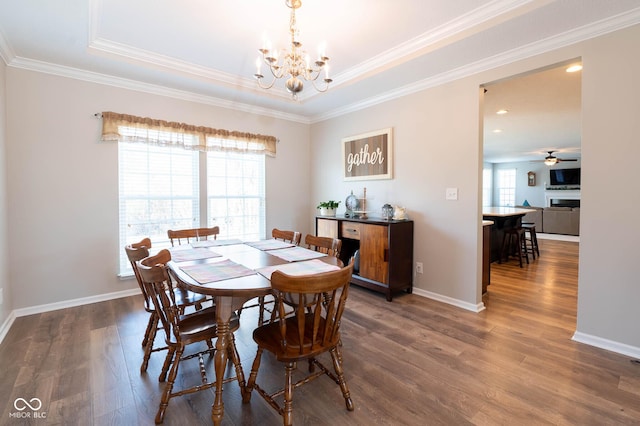 dining room with dark wood finished floors, baseboards, and ornamental molding