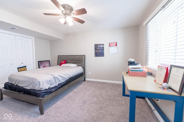 carpeted bedroom with a ceiling fan, baseboards, visible vents, a closet, and baseboard heating