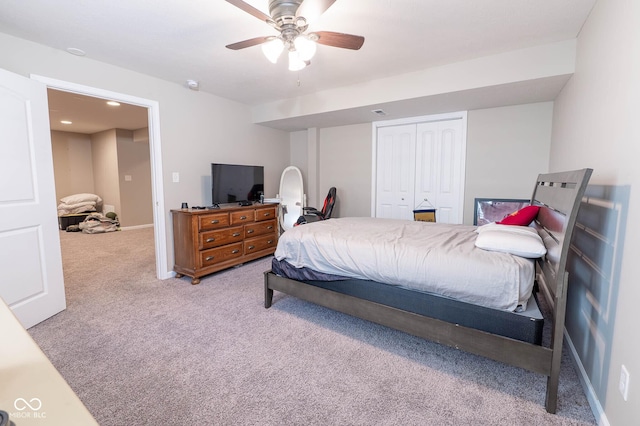 bedroom with a ceiling fan, carpet, a closet, and baseboards